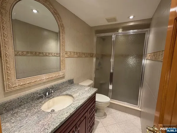 a kitchen with granite countertop wooden cabinets stainless steel appliances and a window