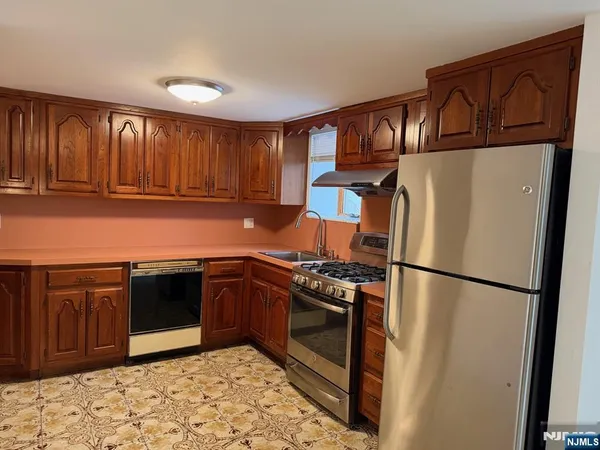 a kitchen with granite countertop a stove and a sink