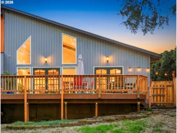a view of a house with a wooden deck
