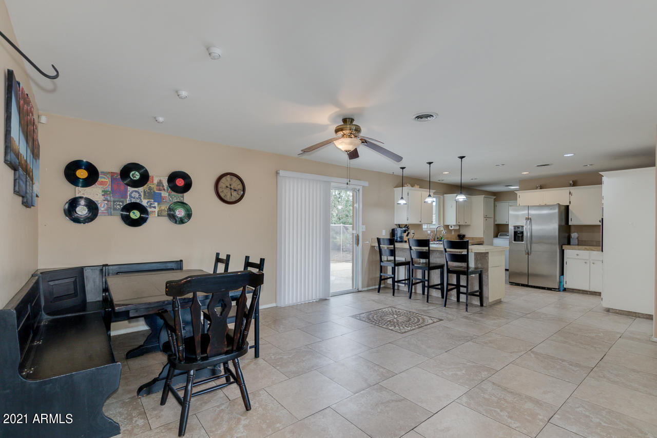 4215 West Dailey Street Phoenix, AZ 85053 - Photo 9 of 32 a view of a dining room and kitchen with furniture and a chandelier