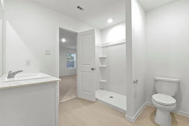 a bathroom with a toilet sink and shower
