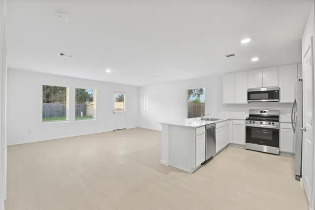 a kitchen with cabinets and appliances
