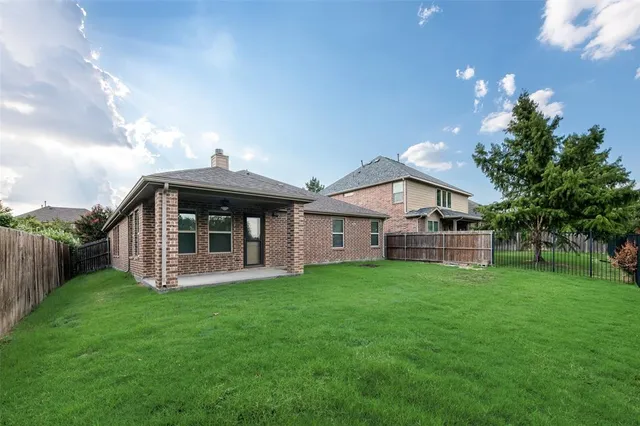 a view of a house with a yard and a porch