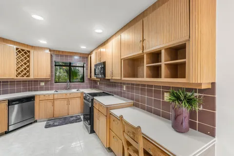 a kitchen with stainless steel appliances a refrigerator and a stove top oven