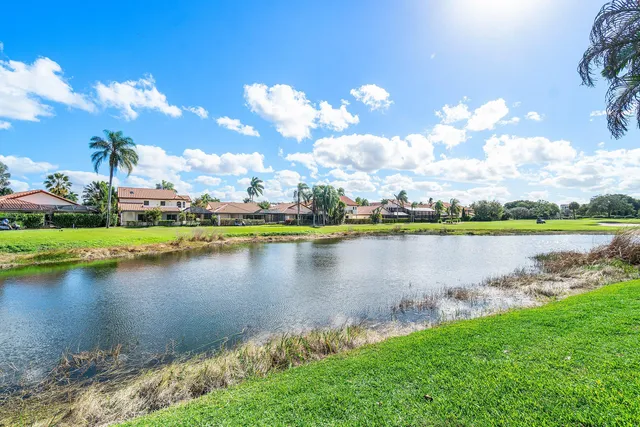 a view of a lake with houses in the back