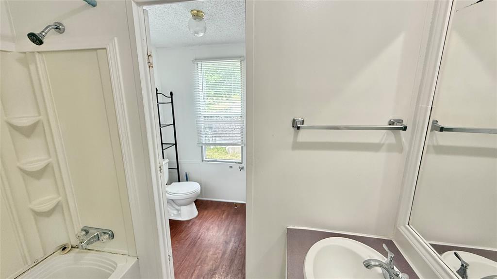 3789 Jacobs Lane Kaufman, TX 75142 - Photo 23 of 33 a bathroom with a granite countertop sink toilet and shower