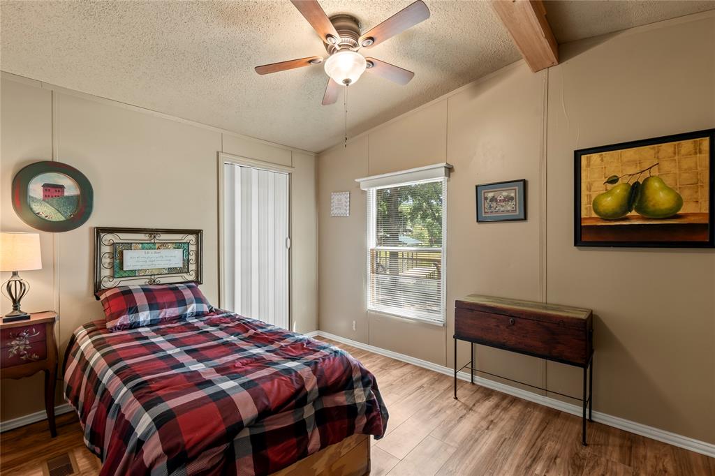 194 Indian Gap Road Mabank, TX 75156 - Photo 14 of 18 a bedroom with a bed and a window
