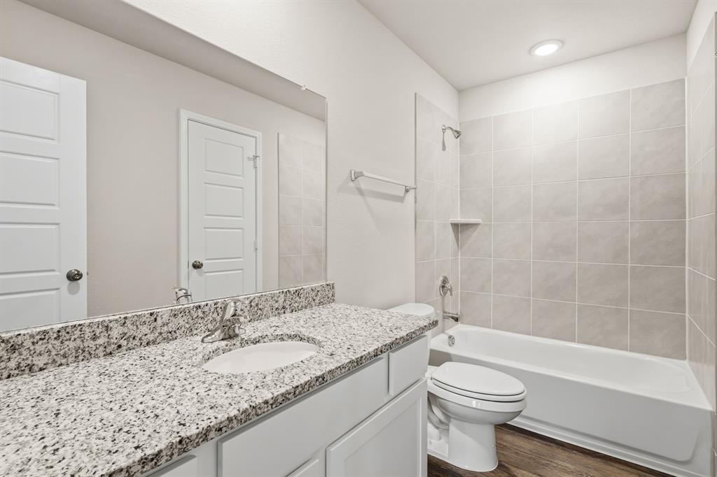 10608 Brocket Lane Crowley, TX 76036 - Photo 19 of 40 a bathroom with a granite countertop sink toilet and shower