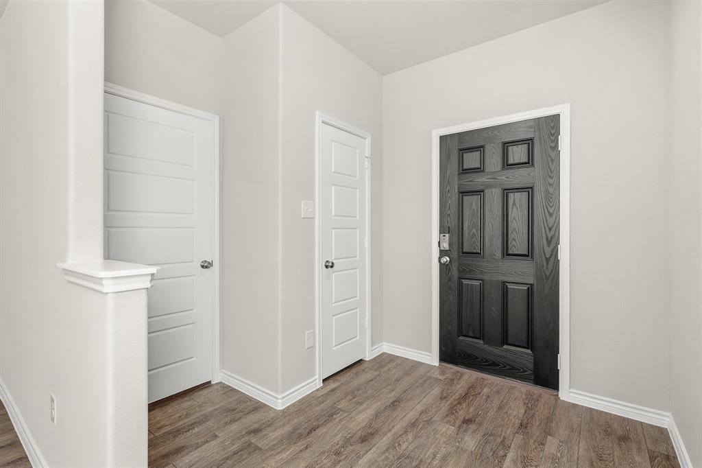 10608 Brocket Lane Crowley, TX 76036 - Photo 3 of 40 an empty room with wooden floor closet and windows