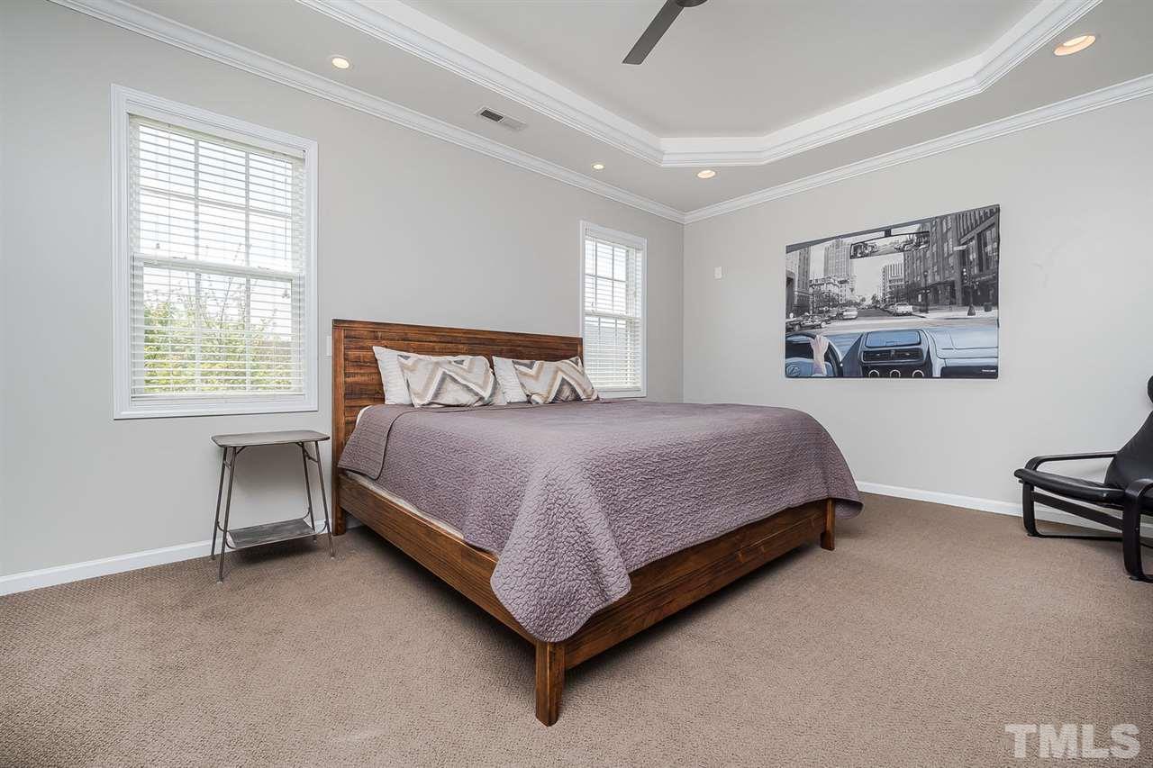 1369 Regulator Street Raleigh, NC 27603 - Photo 13 of 22 a bedroom with a bed lamp and a window