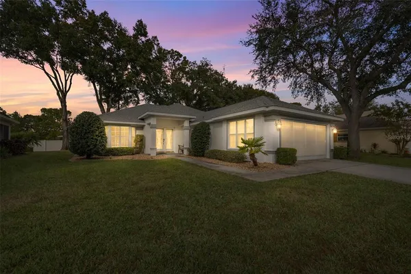 a view of a house with a backyard