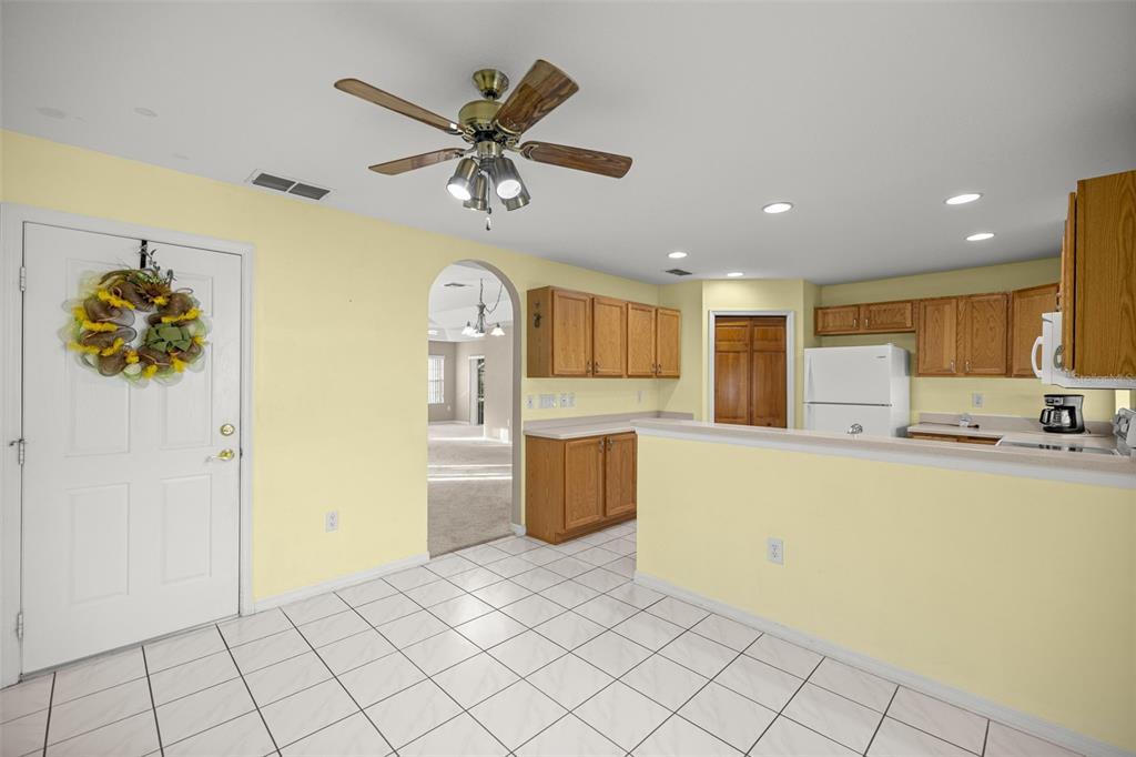 10970 Southwest 69th Circle Ocala, FL 34476 - Photo 11 of 50 a view of a kitchen with furniture and a refrigerator