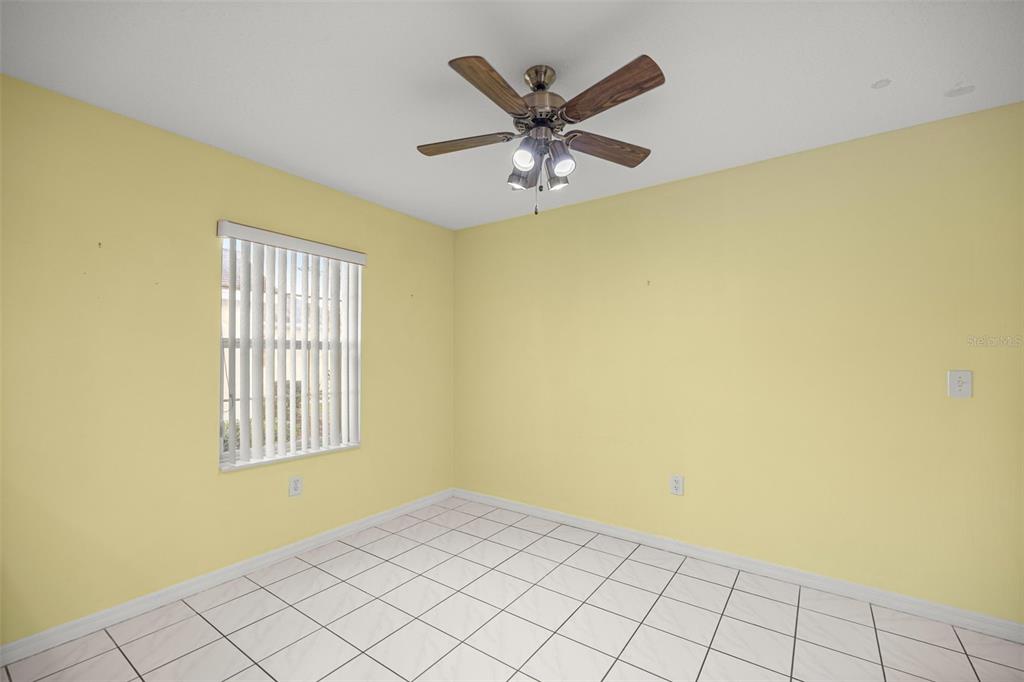 10970 Southwest 69th Circle Ocala, FL 34476 - Photo 12 of 50 an empty room with windows and fan