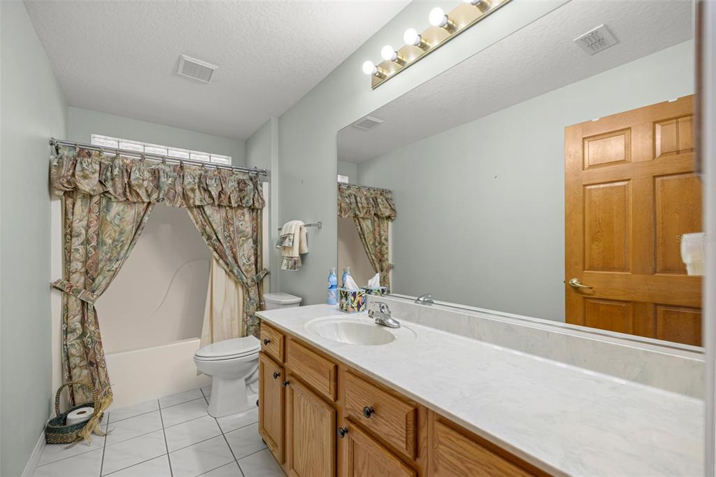 10970 Southwest 69th Circle Ocala, FL 34476 - Photo 16 of 50 a bathroom with a double vanity sink toilet and a mirror