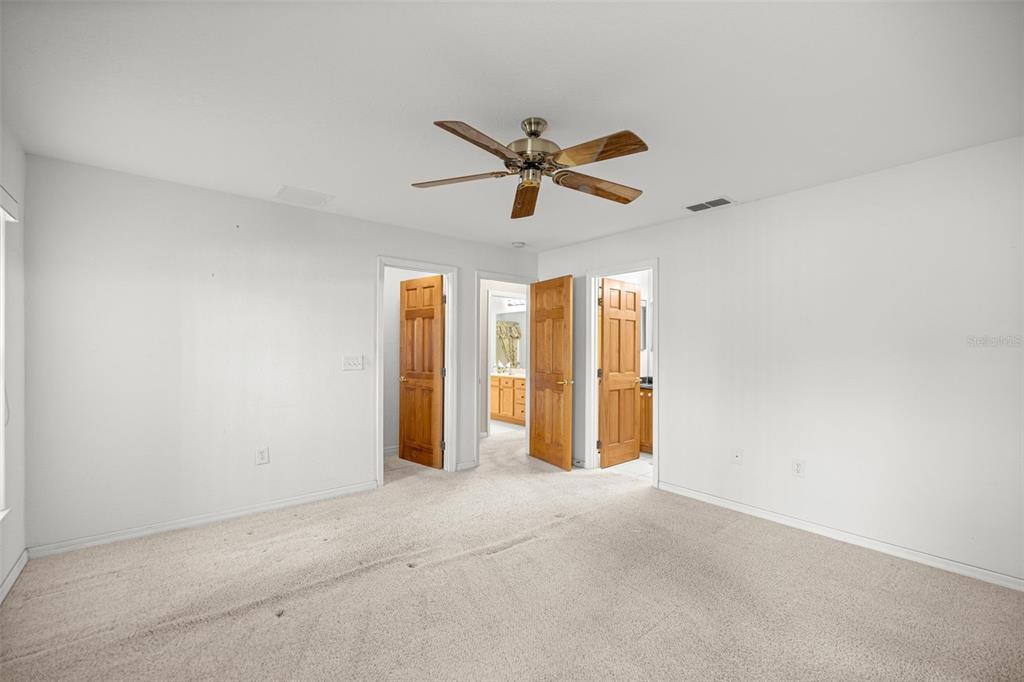 10970 Southwest 69th Circle Ocala, FL 34476 - Photo 18 of 50 an empty room with chandelier fan and windows