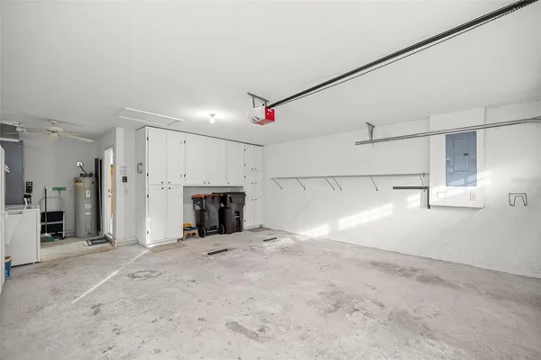 a view of a empty room with fireplace and windows