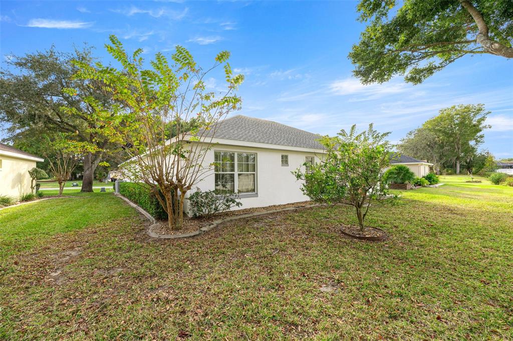 10970 Southwest 69th Circle Ocala, FL 34476 - Photo 29 of 50 a front view of a house with garden