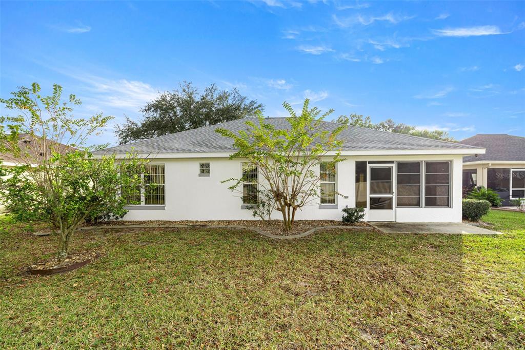 10970 Southwest 69th Circle Ocala, FL 34476 - Photo 30 of 50 front view of a house with a yard
