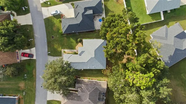 an aerial view of a house with a yard