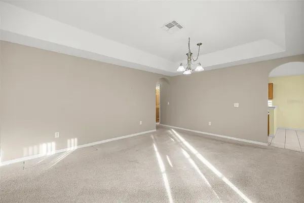 a view of a chandelier fan and entryway