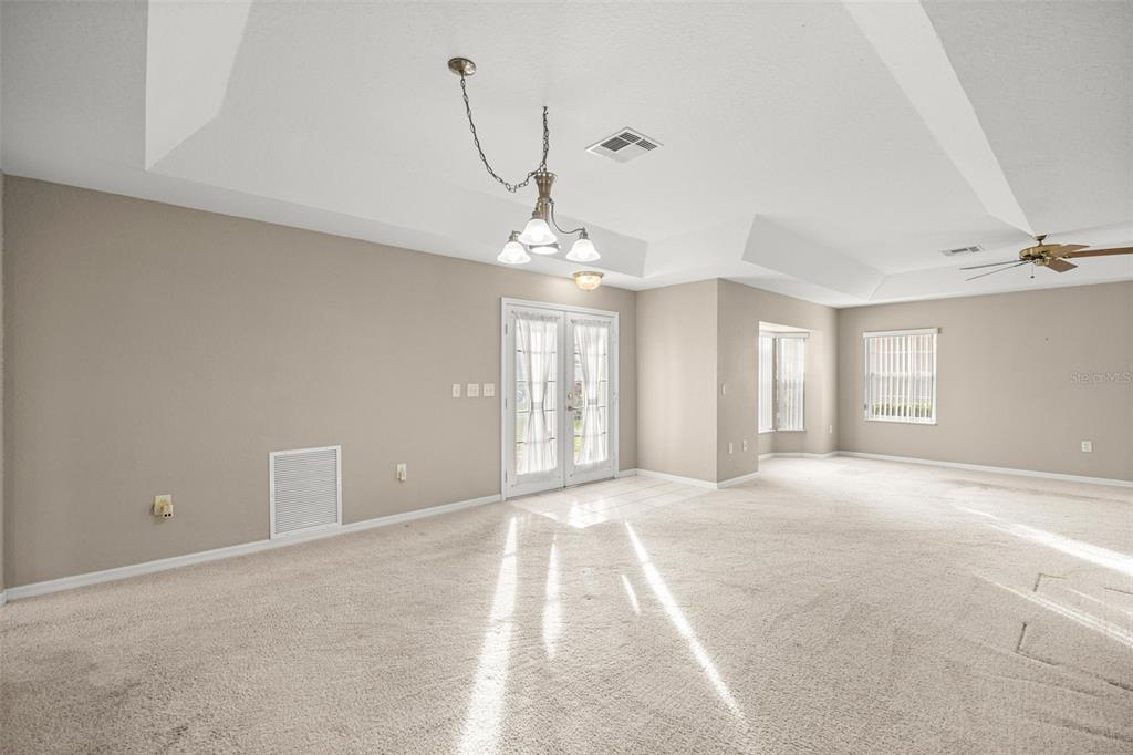 10970 Southwest 69th Circle Ocala, FL 34476 - Photo 5 of 50 a view of a big room with windows and chandelier