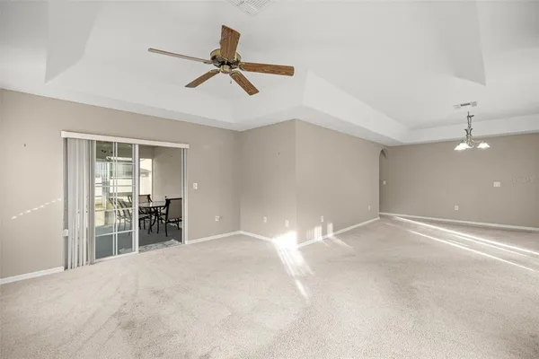 a view of a livingroom with a ceiling fan and window
