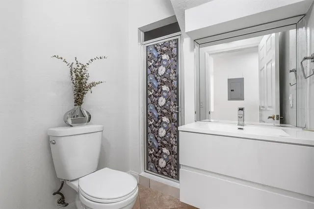 an empty room with a window and a ceiling fan