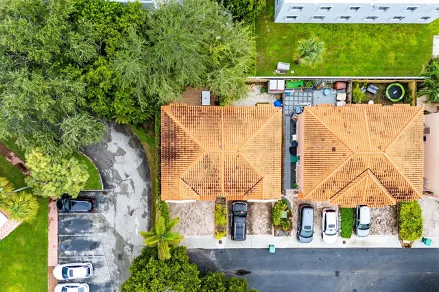 an aerial view of a house with a yard and garden