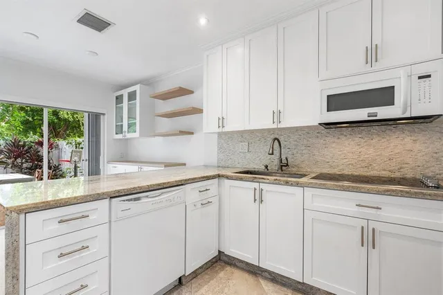 a kitchen with appliances cabinets and a sink