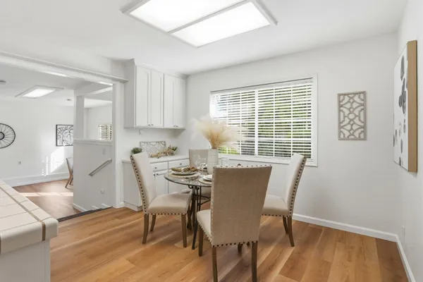 a view of a dining room with furniture windows and wooden floor