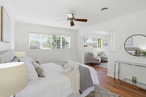 a bedroom with a bed a mirror and furniture