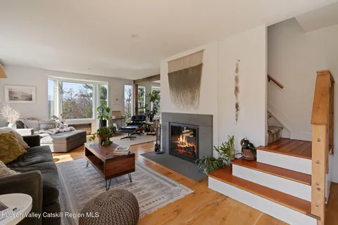 a living room with furniture fireplace and window