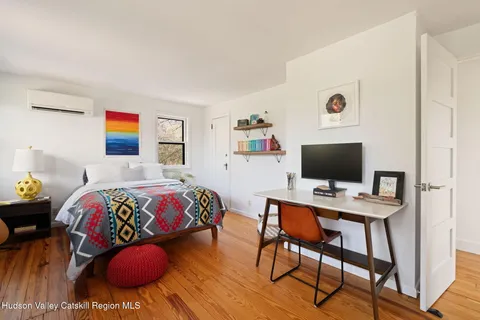 a bedroom with a bed and a desk