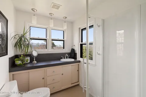 a bathroom with a double vanity sink and a mirror