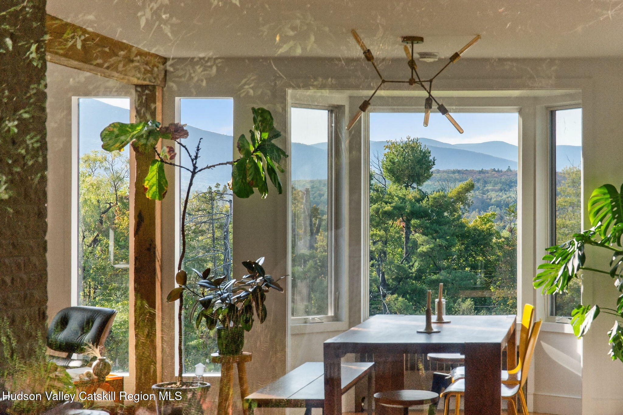 4701 Atwood Road Stone Ridge, NY 12484 - Photo 4 of 41 a view of a porch with a table and chairs potted plants