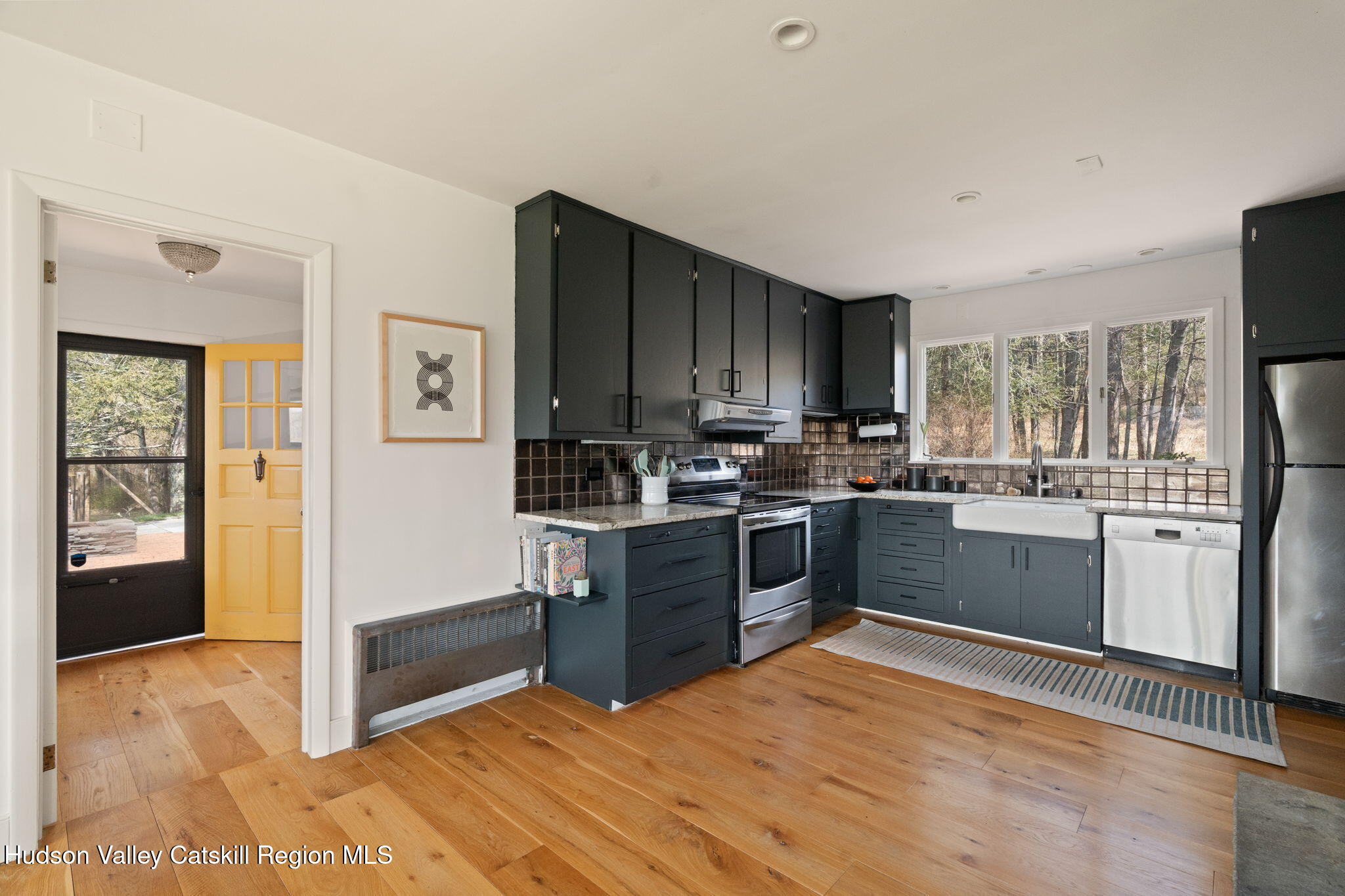 4701 Atwood Road Stone Ridge, NY 12484 - Photo 5 of 41 a kitchen with granite countertop a stove a sink dishwasher a refrigerator and a oven with wooden floor