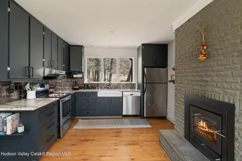 a kitchen with a sink a refrigerator and a stove top oven
