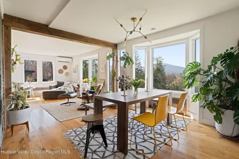 a view of a dining room with furniture window and wooden floor