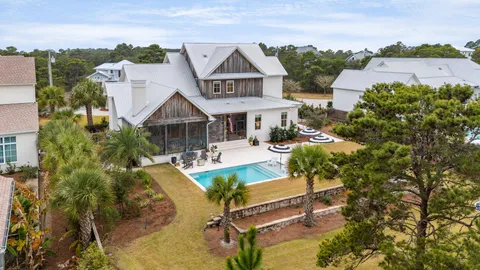 an aerial view of a house with swimming pool backyard and patio
