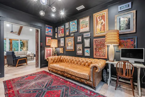 a living room with hard wood floors and a book shelf
