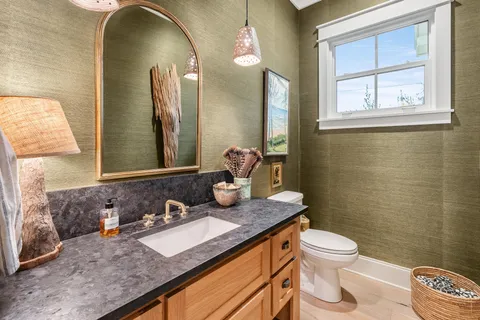 a kitchen with stainless steel appliances granite countertop a sink a stove and a refrigerator