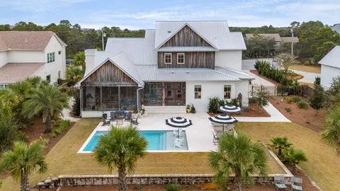an aerial view of a house with swimming pool garden and patio