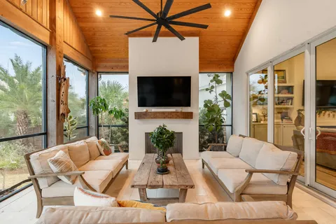 a bedroom with a bed a mirror on dresser and a window