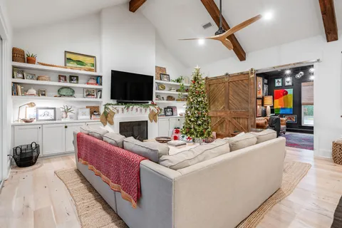 a bedroom with a bed next to a window