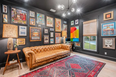 a living room with hard wood floors and a book shelf