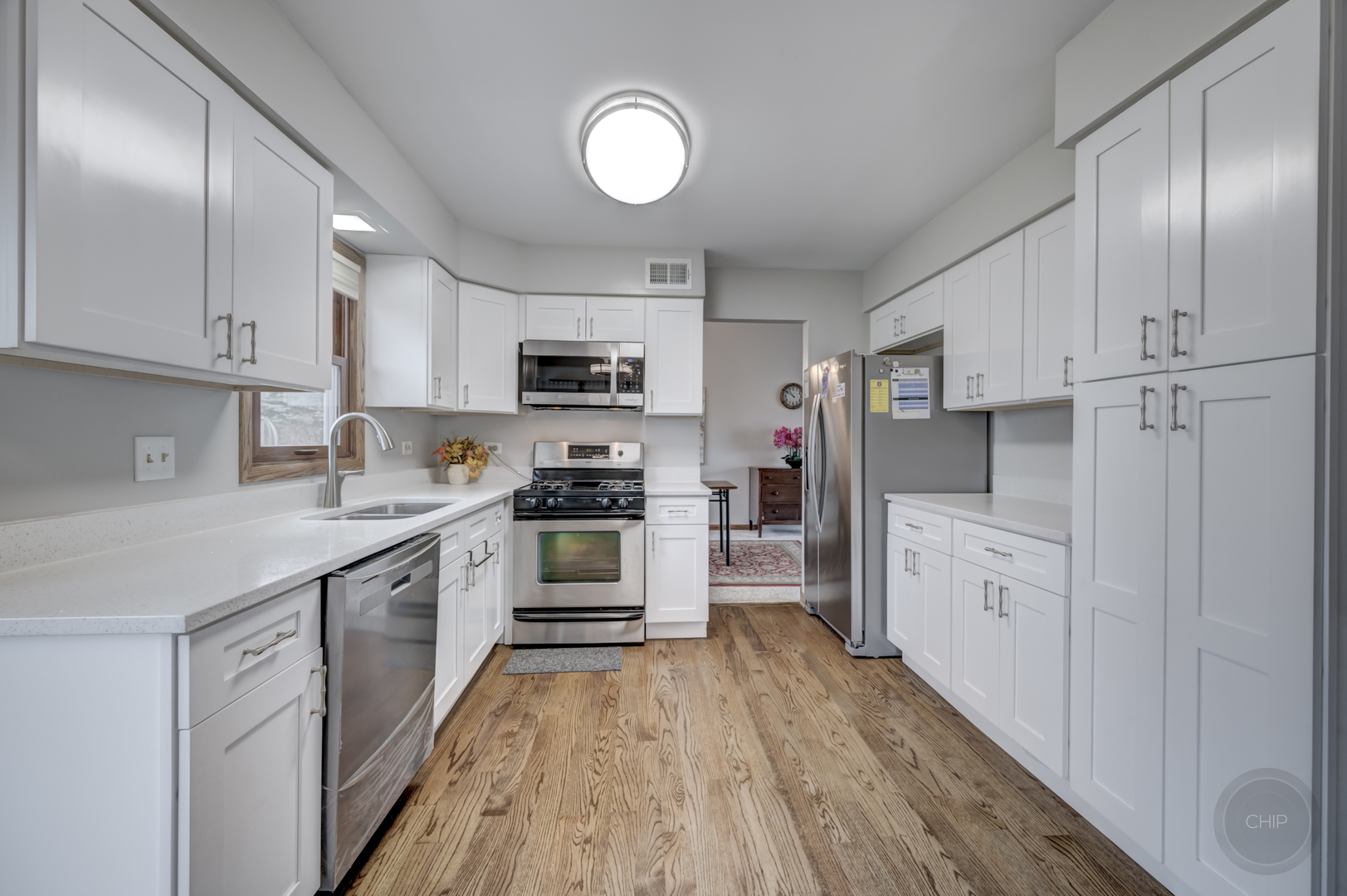 2820 Sun Valley Road Lisle, IL 60532 - Photo 24 of 46 a kitchen with white cabinets and stainless steel appliances