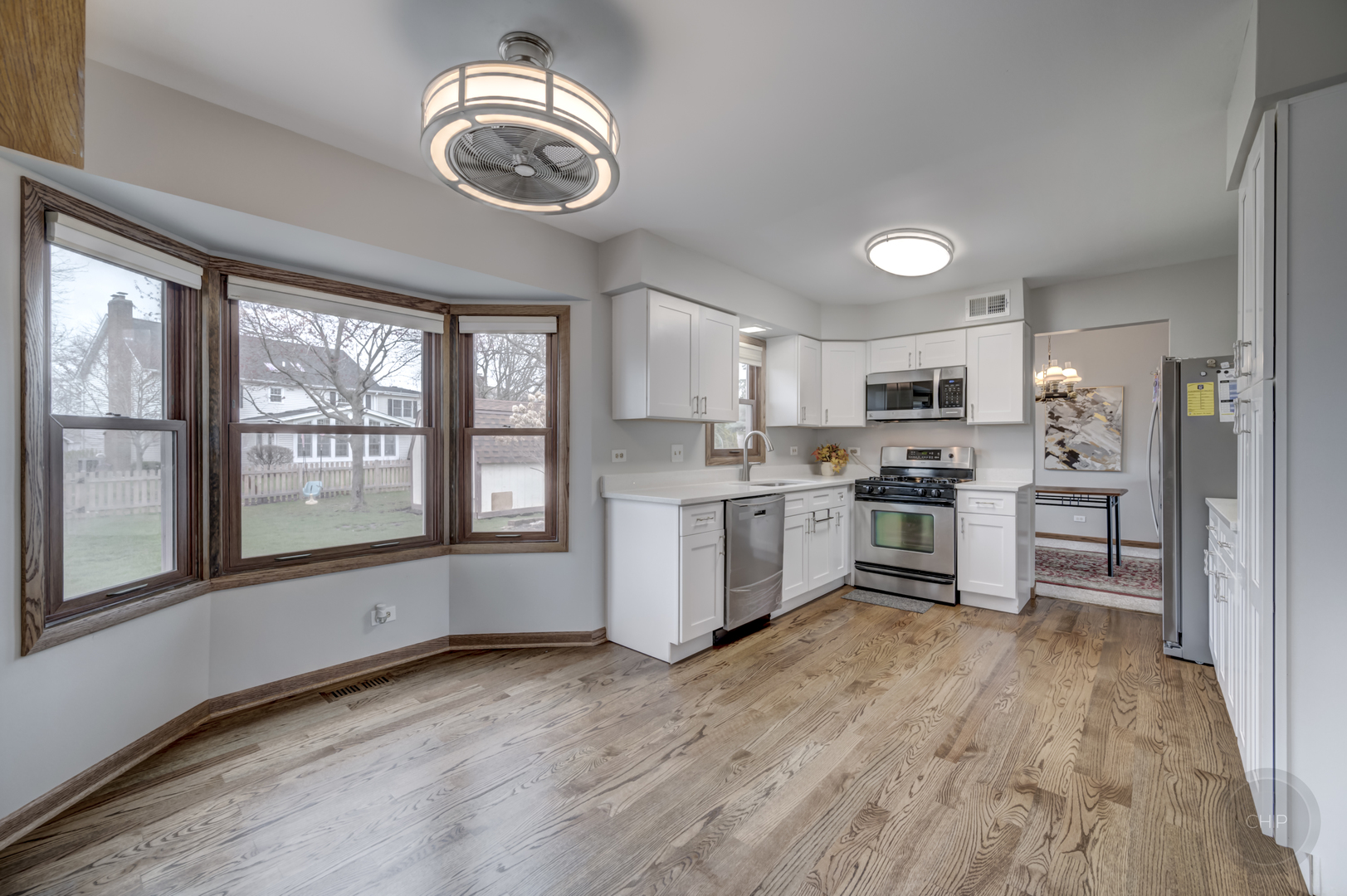 2820 Sun Valley Road Lisle, IL 60532 - Photo 26 of 46 a kitchen with stainless steel appliances granite countertop a stove top oven a sink dishwasher a refrigerator and white cabinets with wooden floor