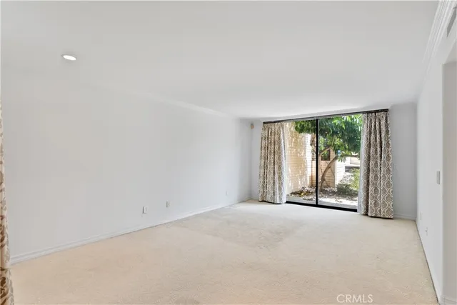 a view of an empty room with glass door