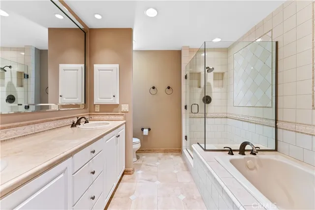 a spacious bathroom with a tub sink shower and mirror