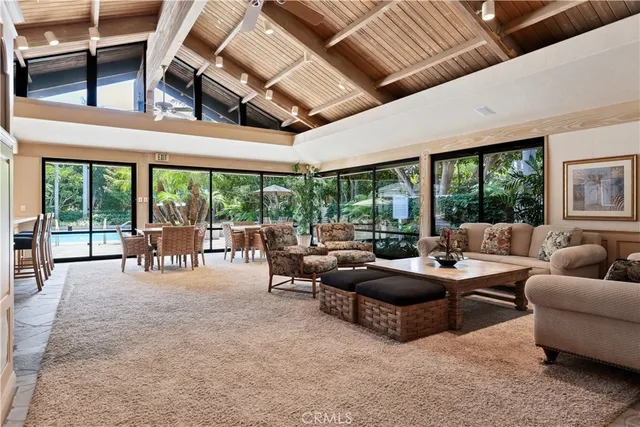 a living room with furniture and a floor to ceiling window